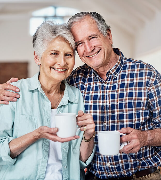 An older couple smiling together at home
